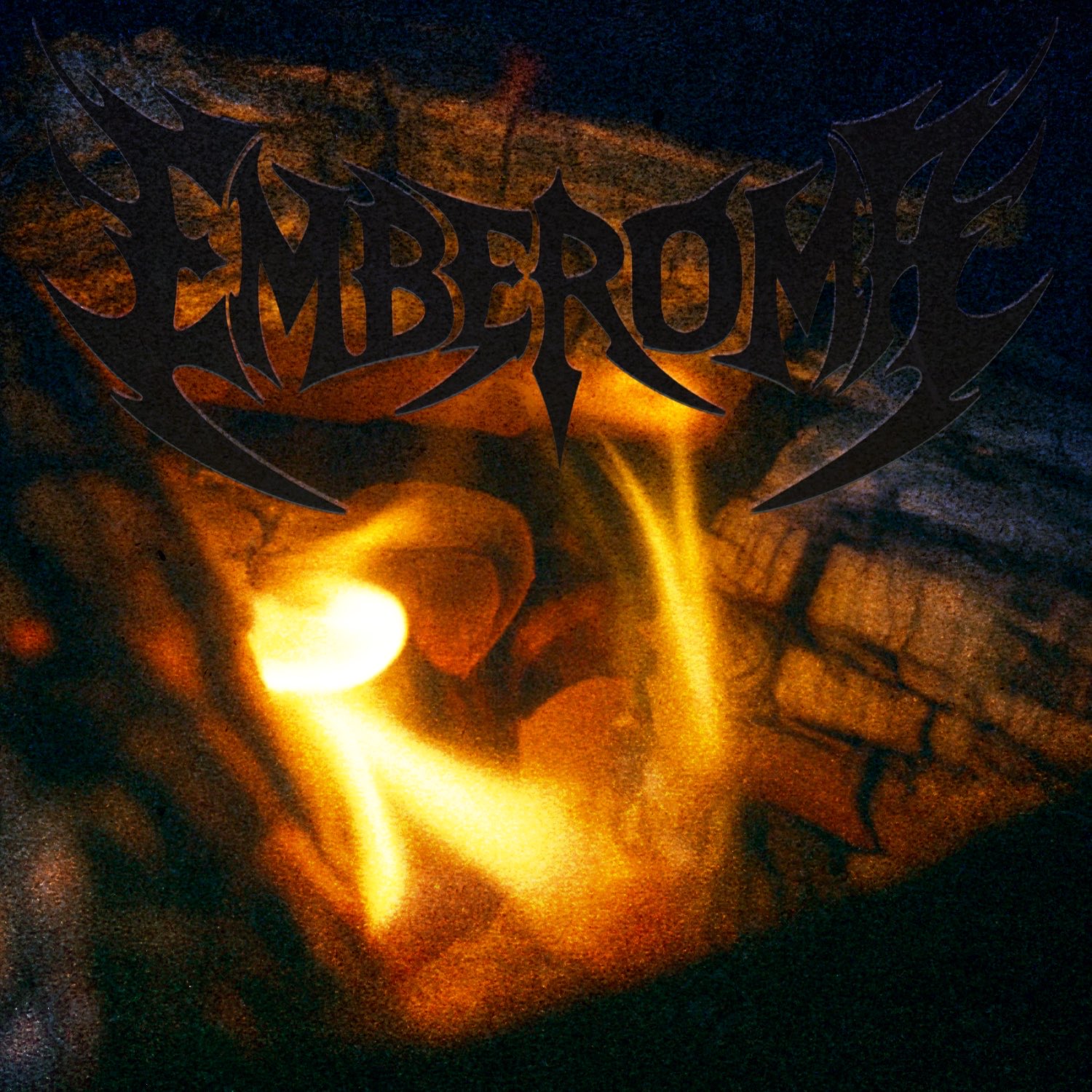 A flame burning under wood logs.